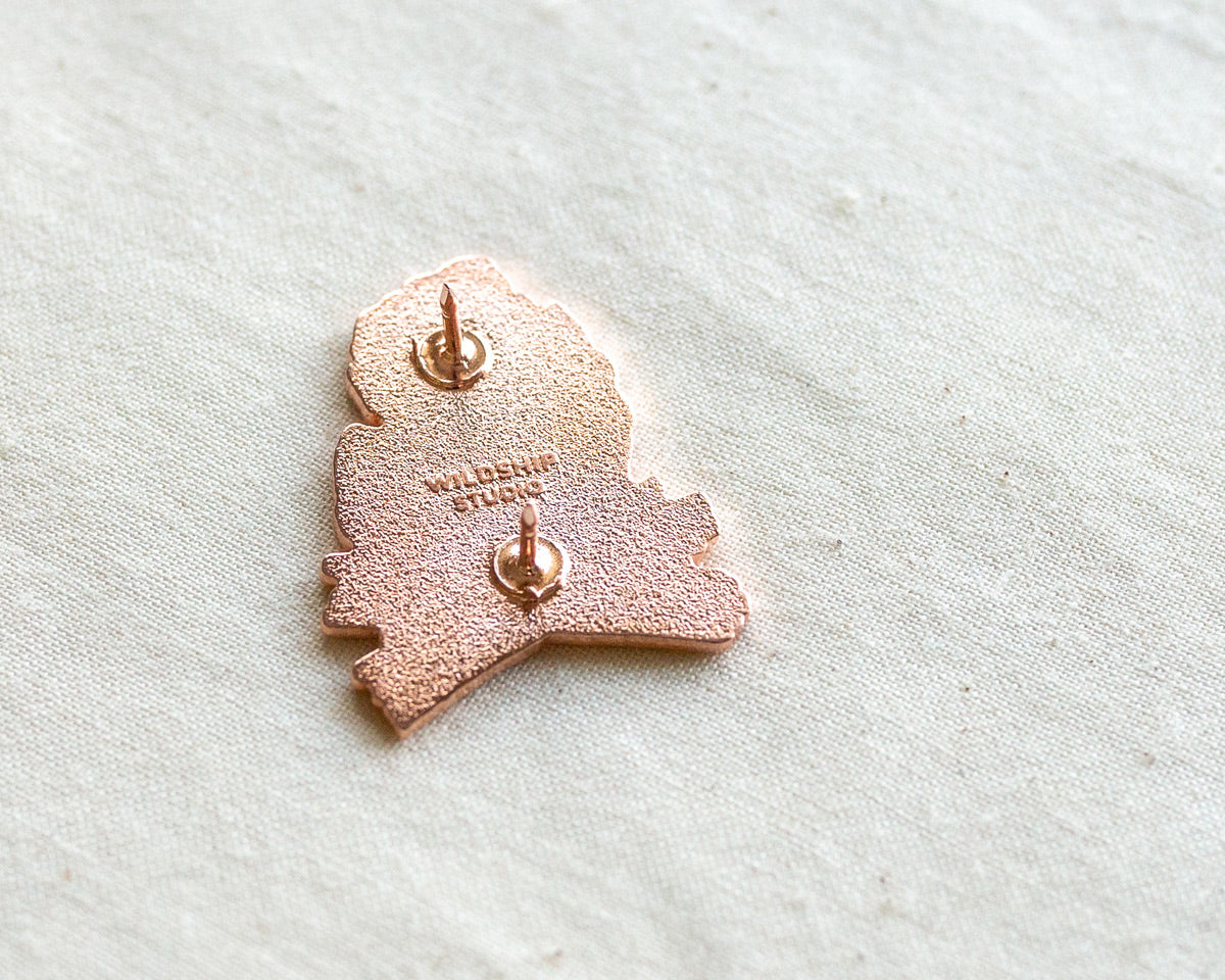the backside of copper michigan enamel pin