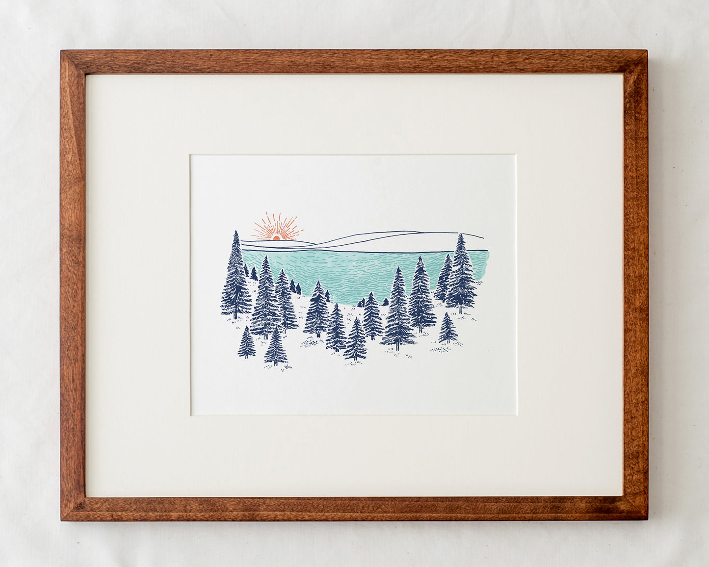 lakeshore art print with pine trees illustration in natural wood frame