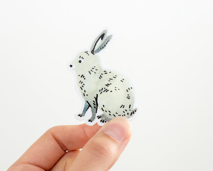 a hand holding a cute bunny rabbit vinyl sticker by wildship studio