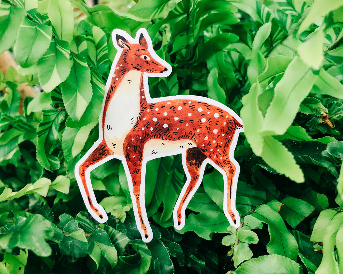 cute deer vinyl animal sticker art by wildship studio against a plant background