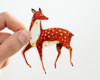 hand holding a cute deer vinyl sticker by wildship studio