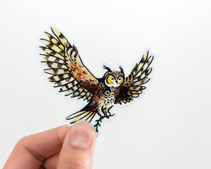 hand holding a cute owl vinyl sticker by wildship studio