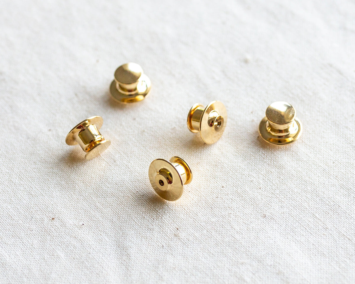 set of five deluxe gold locking pin backs