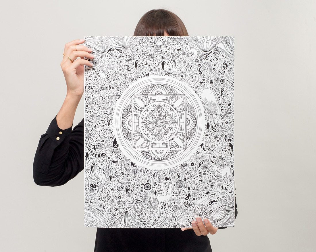 Woman displaying black and white illustrated nirvana lotus art print