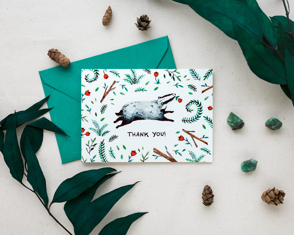 thank you card and envelope with a cute woodland badger styled with pinecones and greenery